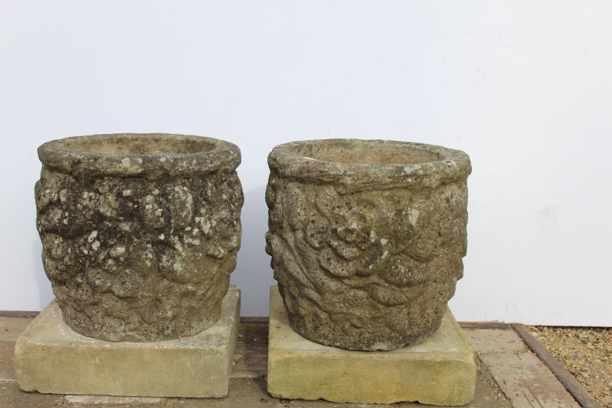 Pair of round stone planters with floral design
